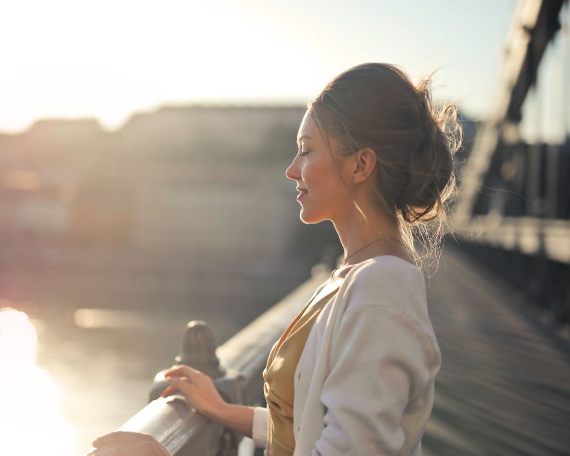 Woman in peaceful moment at sunset